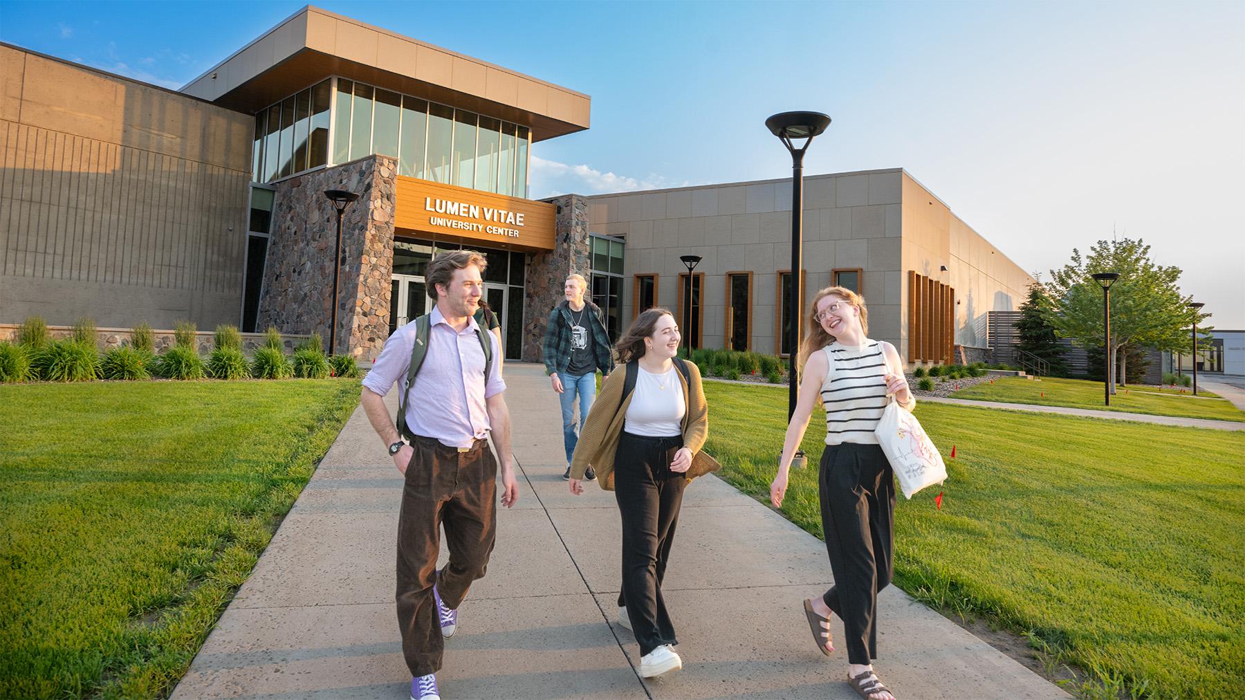 students walking outside the Lumen Vitae center
