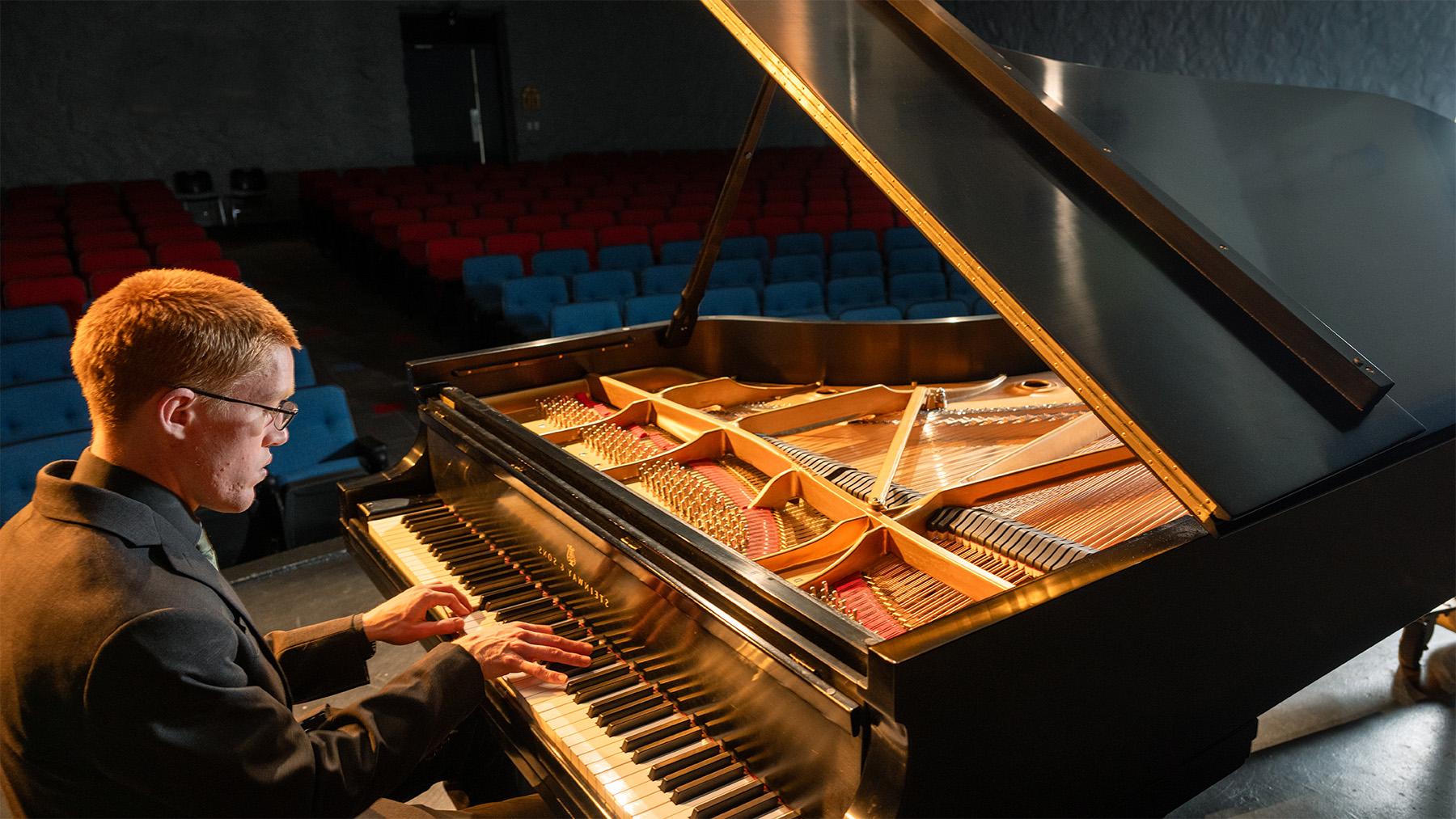 student playing the piano in Arno Gustin Hall