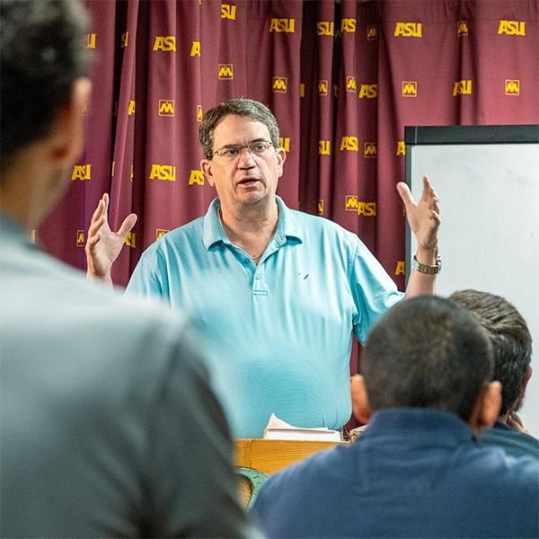 a male professor giving a lecture.