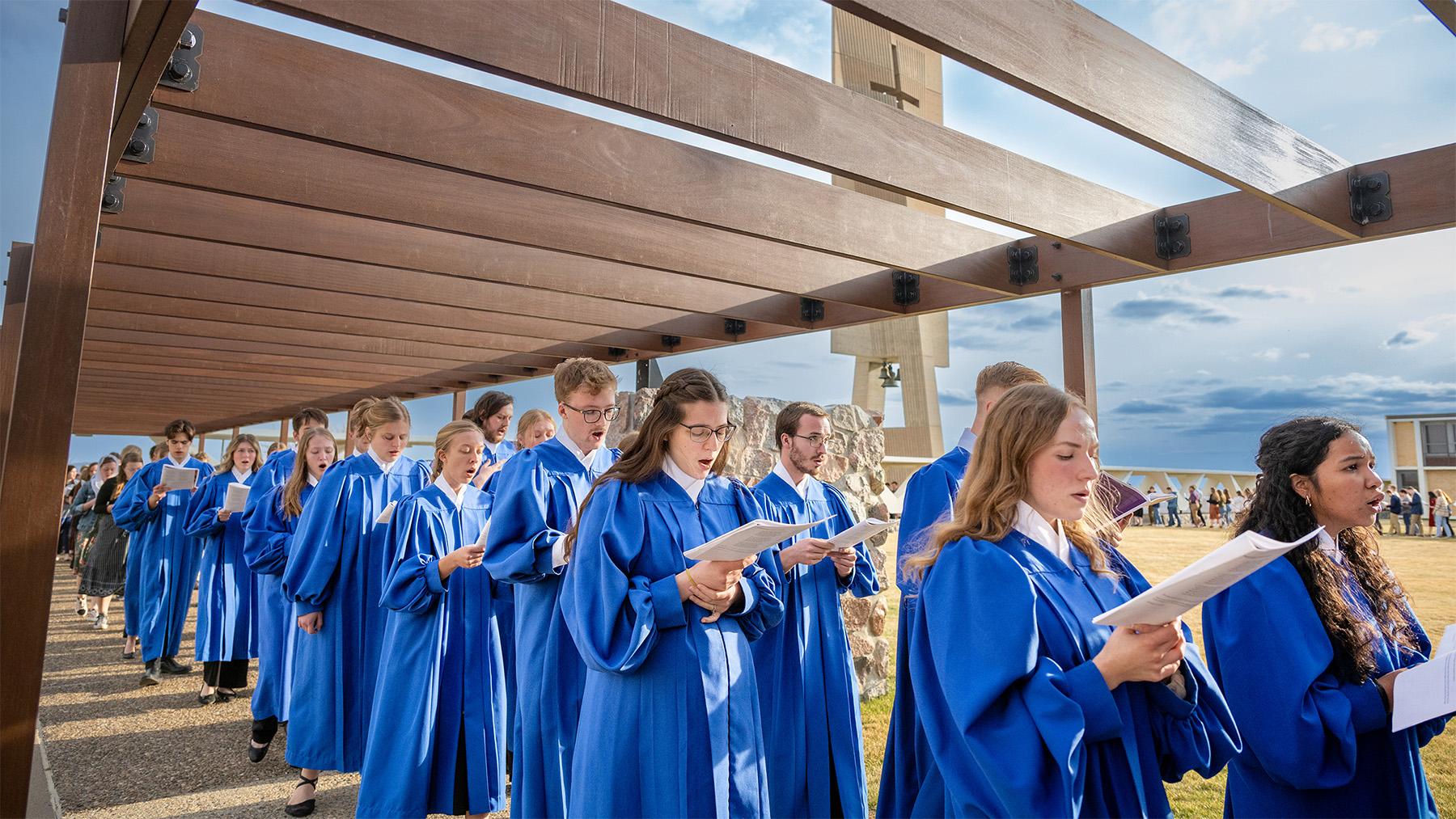 Cappella students singing in a church procession