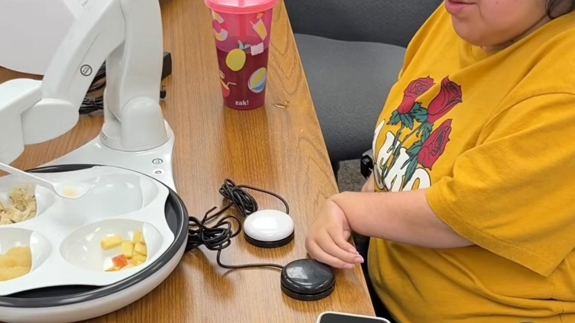 Fargo woman feeding herself for the first time