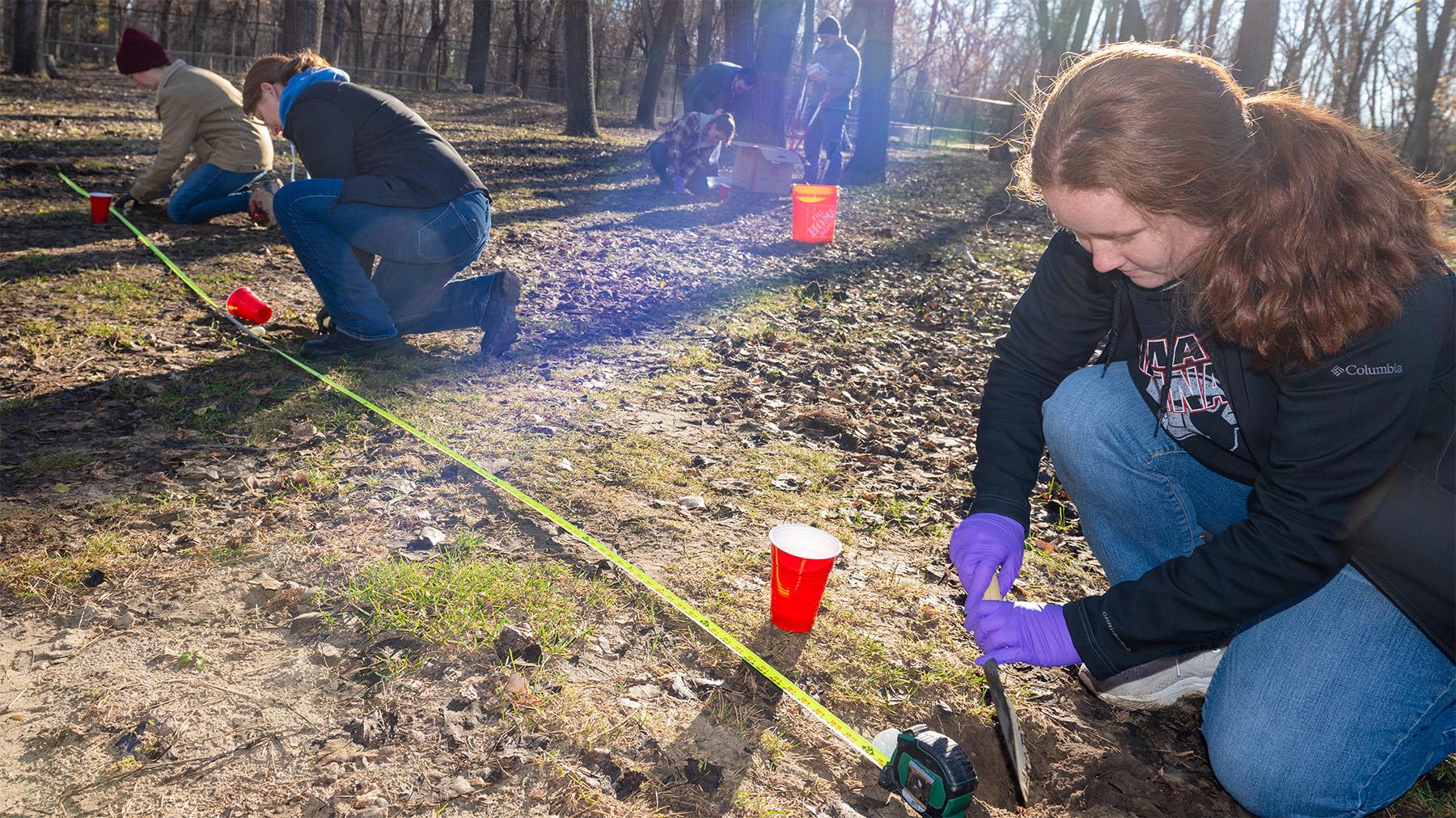 Student digging soil samples
