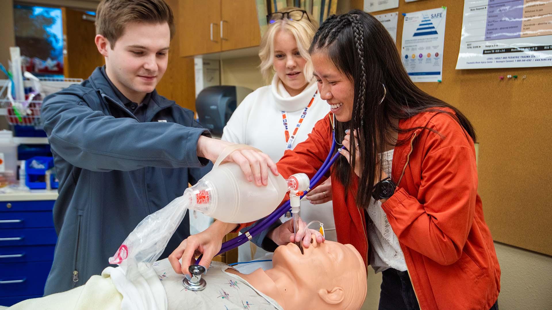 RT students training in lab with faculty member